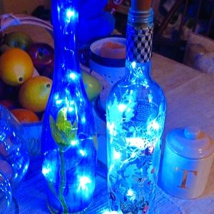 2 empty decorative bottle s with lights